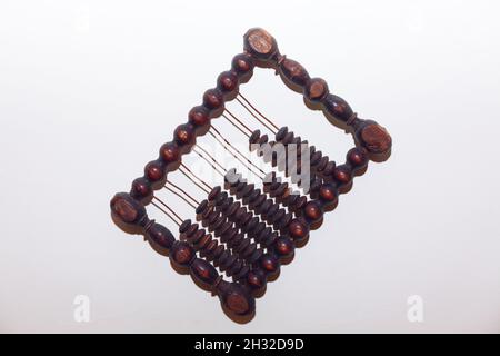 Old abacus on the white wall . Ancient counting frame . Antique calculating tool Stock Photo