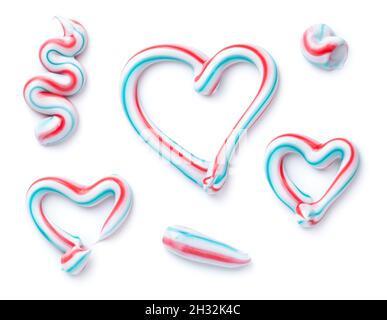 Three colored toothpaste sample set isolated over white background. Top view, flat lay Stock Photo