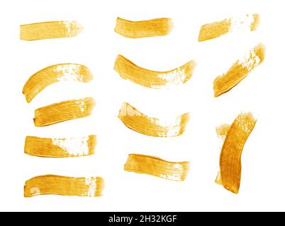 Set of golden paint strokes isolated on white background Stock Photo