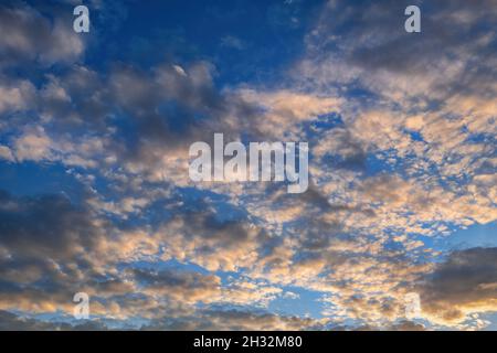 Sky covered with clouds at sunset, nature background Stock Photo