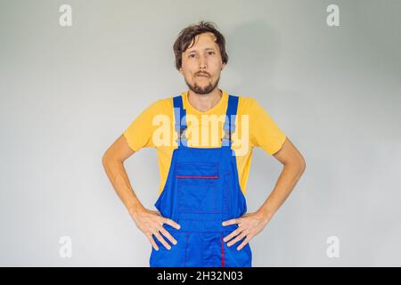 Builder thinking. Man in builder uniform pondered. Portrait of builder thinking about something. Architect Engineer on white background. Construction Stock Photo