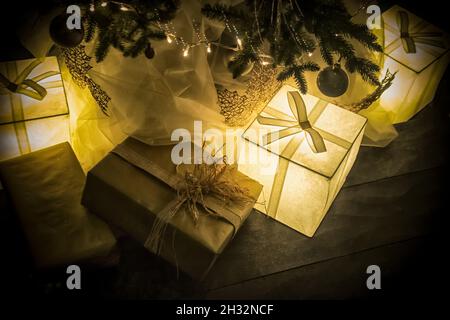 Illuminated presents under the Christmas tree Stock Photo