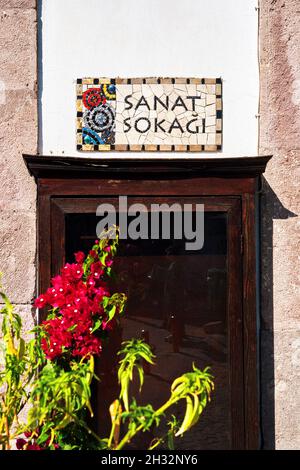 Urla, Turkey - September, 2021: The ceramic street sign of the art street (sanat sokagi) in Urla, Izmir, Turkey. Stock Photo