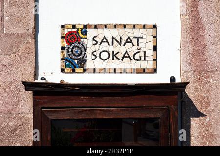 Urla, Turkey - September, 2021: The ceramic street sign of the art street (sanat sokagi) in Urla, Izmir, Turkey. Stock Photo