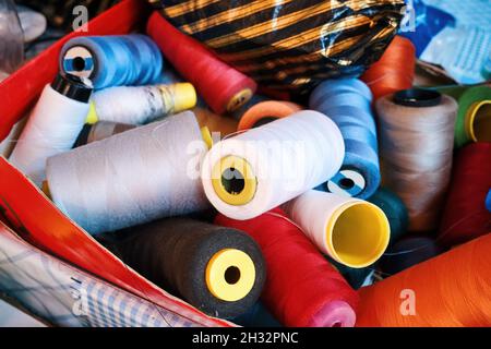 Colorful sewing threads in a basket Stock Photo
