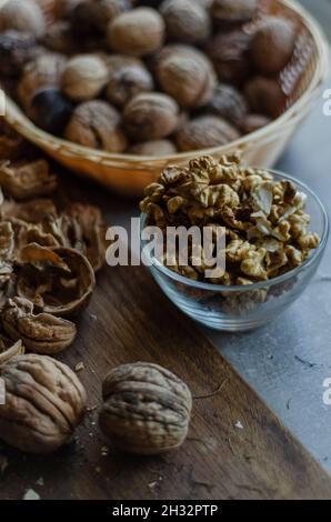 peeled walnuts in a vase and in a shell in a basket Stock Photo