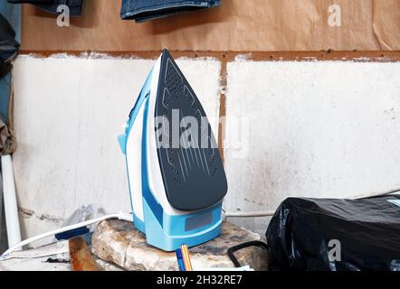 Steam iron on a tailor workbench Stock Photo