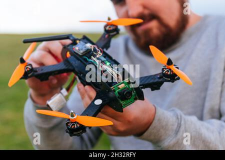Man holding a racing drone. FPV high-speed racing drone. Photographers go to drone. Stock Photo