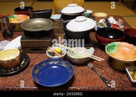 shibu onsen, nagano, japan, 2021-20-10 , Dirty dishes on the table after a Meal at a traditional Ryokan with different dishes of the Japanese cuisine. Stock Photo