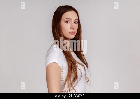 Portrait of confident woman with black hair wearing white t-shirt stock  photo