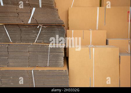 Stack of brown folded cardboard boxes tied for packaging Stock Photo