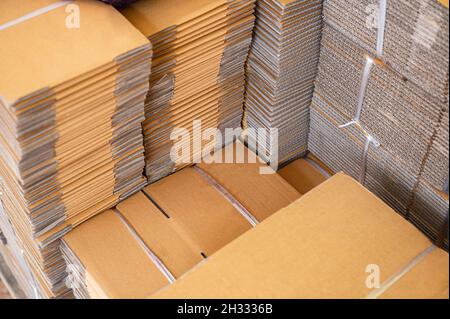 Stack of brown folded cardboard boxes tied for packaging Stock Photo