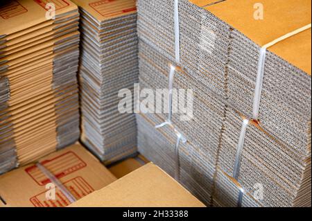 Stack of brown folded cardboard boxes tied for packaging Stock Photo