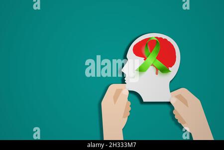 Human Brain With Green awareness Ribbon. Mental health and brain care concept. Man Head, Blue Background Stock Photo