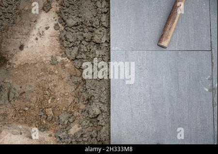 Mallet and tools on granite tile during laying floor Stock Photo