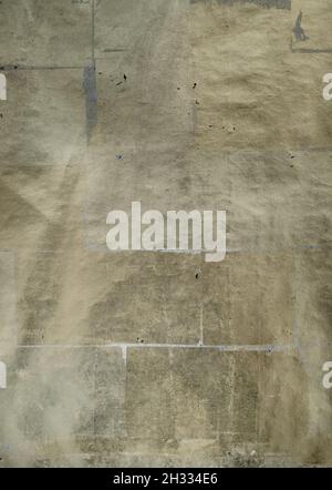Abstract background of sheets of golden paper glued on a large cardboard Stock Photo