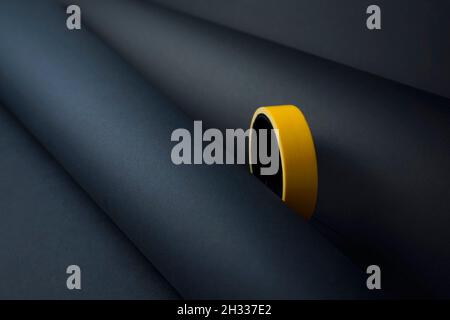 Creative minimal paper with yellow tape object abstract background. Rolled papers with colored adhesive insulating duct tape texture idea concept. Stock Photo