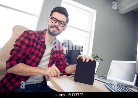 Portrait of attractive cheerful smart experienced guy fixing making upgrade doing service support at work place station indoors Stock Photo