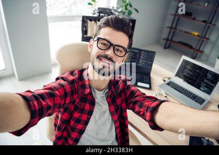 Self-portrait of attractive intellectual cheerful skilled guy hacker online manager writing code database day at work place station indoors Stock Photo