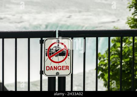 NIAGARA FALLS, ONTARIO, CANADA - MAY 29, 2016: Danger warning sign on metal fence near Niagara Falls Stock Photo