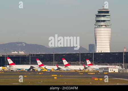 VIENNA, AUSTRIA - Nov 03, 2018: View of Vienna Airport with terminal, air traffic control tower and parking aircrafts of Austrian Airlines Stock Photo