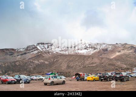 Cars parked near to Chimborazo volcano.  Riobamba, Chimborazo, Ecuador Stock Photo
