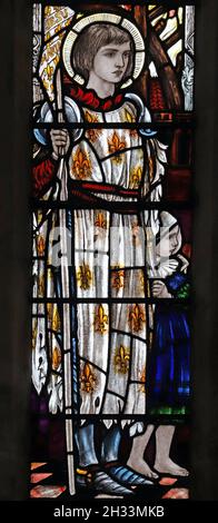 A stained glass window by Christpher Whall Studios 1920 depicting St Joan of Arc, St Leonard's Church, Apethorpe, Northamptonshire Stock Photo