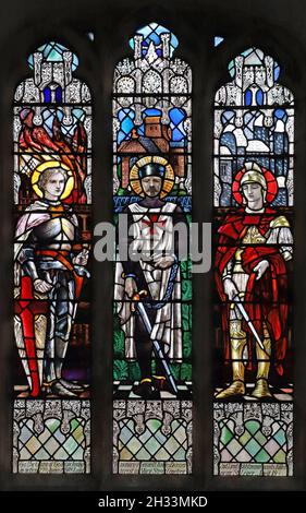 A stained glass window by Christpher Whall Studios 1920 depicting French Saints, St Leonard's Church, Apethorpe, Northamptonshire Stock Photo