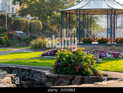 Bandstand and formal gardens on the seafront promenade at Ilfracombe a popular seaside resort on the North Devon coast in south west England UK Stock Photo