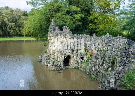 The Crystal Grotto folly and lake at Painshill Park, Cobham, Surrey, south-east England in autumn Stock Photo