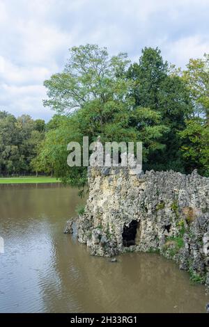 The Crystal Grotto folly and lake at Painshill Park, Cobham, Surrey, south-east England in autumn Stock Photo