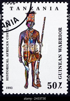 TANZANIA - CIRCA 1993: a stamp printed in Tanzania shows Guinean Warrior, Historical African Costumes, circa 1993 Stock Photo