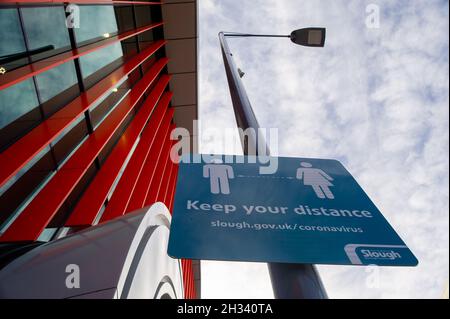 Slough, Berkshire, UK. 25th October 2021. A Slough Council Covid-19 Keep Your Distance sign in Slough. The number of positive Covid-19 cases in Slough have risen to 480 from 419 per 100,000 people in the seven days up to and including 18 October compared with the week before. Credit: Maureen McLean/Alamy Live News Stock Photo