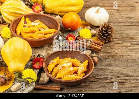 Pumpkin gnocchi or Italian dumplings. Healthy vegetarian squash dish with cottage cheese. Autumn decor with fall leaves, cones, whole pumpkins, flower Stock Photo