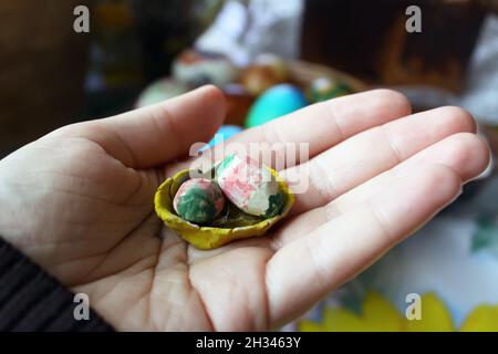 Hand holding stylized decorative handmade easter eggs. Stock Photo