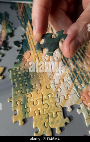 Jigsaw puzzle being assembled Stock Photo