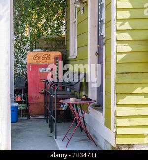 NEW ORLEANS, LA, USA - OCTOBER 23, 2021: Antique Coca Cola machine on front porch of house in Mid City Stock Photo