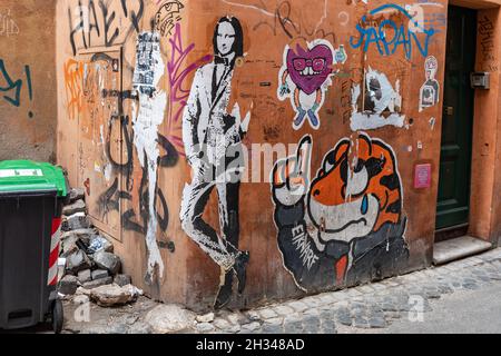 Street art. Cut-to-shape paste-up posters on a street corner in Trastevere district of Rome, Italy. Stock Photo