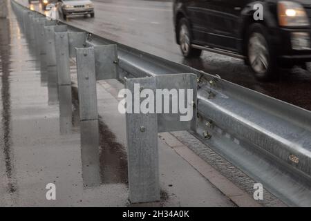 underscrewed nuts and bolts in highway road railing Stock Photo