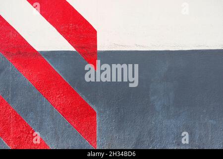 Abstract geometric wall texture background. Old white and gray color cement wall painted with diagonal red stripes Stock Photo