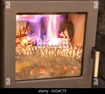 dancing pink and pruple plasma flames from a real wood burner Stock Photo