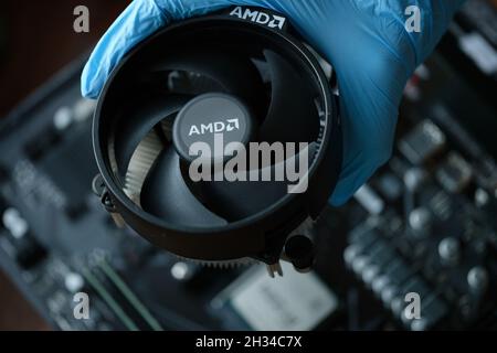 Hand in glove installs cpu fan AMD closeup Stock Photo