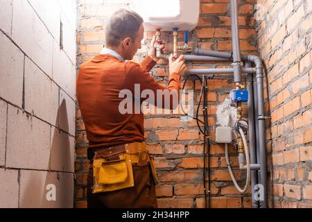 a plumber engineer repairing pipes at work Stock Photo