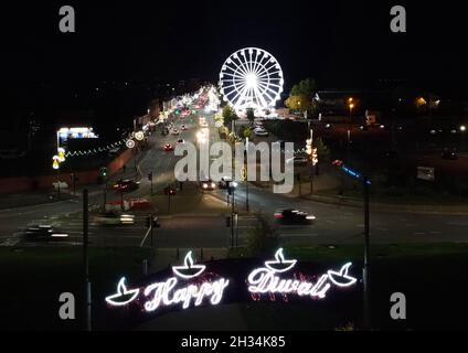 Leicester, Leicestershire, UK. 25th October 2021. A ferris wheel turns in front of Diwali lights on the Golden Mile. With over 6,500 lights the Diwali celebrations in Leicester are regarded as the largest outside of India. Credit Darren Staples/Alamy Live News. Stock Photo