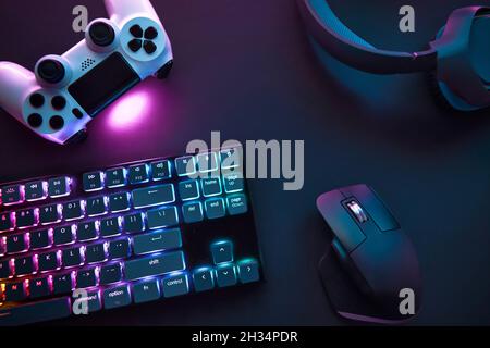 https://l450v.alamy.com/450v/2h34pdr/top-down-view-of-various-gaming-accessories-laying-on-table-colorful-illuminated-devices-professional-computer-game-playing-esport-business-and-onl-2h34pdr.jpg