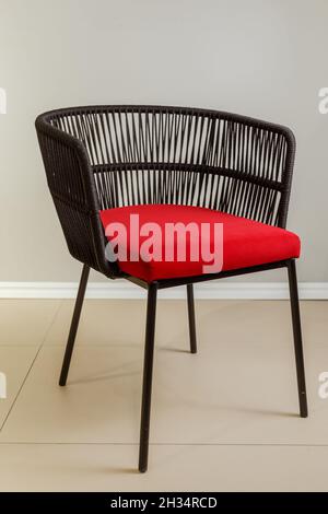 Contemporary wicker kitchen armchair with velour upholstery. Stock Photo