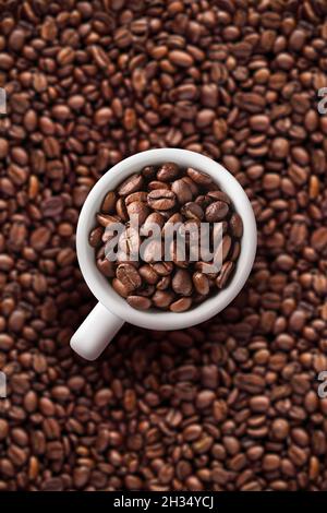 Coffee cup on beans background Stock Photo