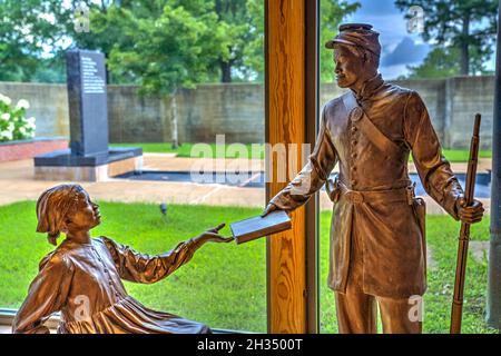 Sculpture of black Union soldier handing book to freed slave girl inside the Corinth Civil War Interpretive Center of Shiloh National Military Park in Stock Photo