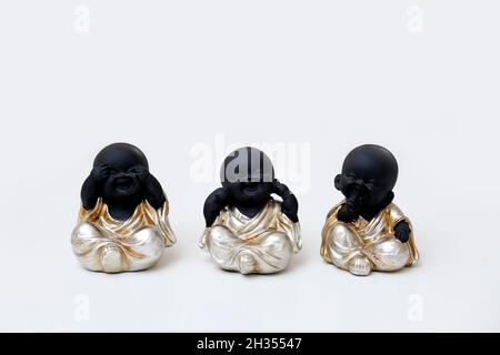 three buddhas black wise puppets 'don't see evil, don't hear evil, don't speak evil' Stock Photo