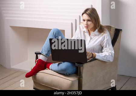 Woman makes online education with help of laptop. Stock Photo